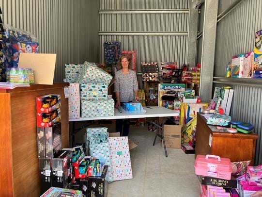 Australian Mutual Bank Deputy Chair Fiona Bennett volunteers in a Christmas present wrapping session with Barnardos Australia in Orange, NSW