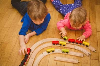 Kids playing with wooden train set Christmas gift