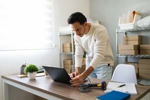 small business owner looking at laptop