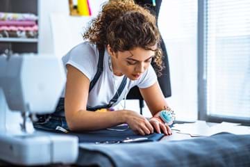 young lady from sewing shop repairing item