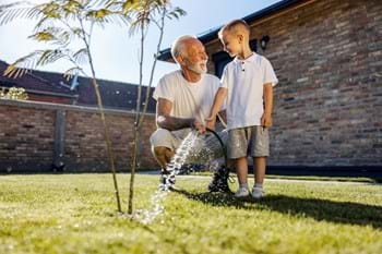 grandad showing grandson the simple gardening ways