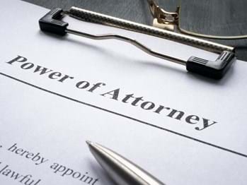 power of attorney document on a clipboard