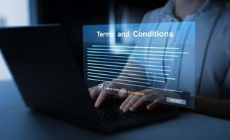 man at computer choosing whether to accept the terms and conditions